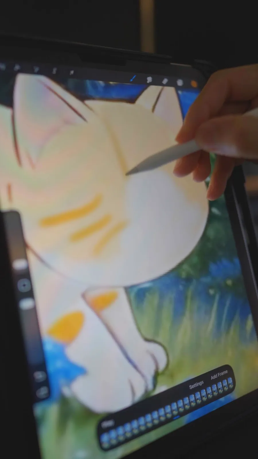 Apple Pencil colouring a cartoon cat on an iPad in Procreate