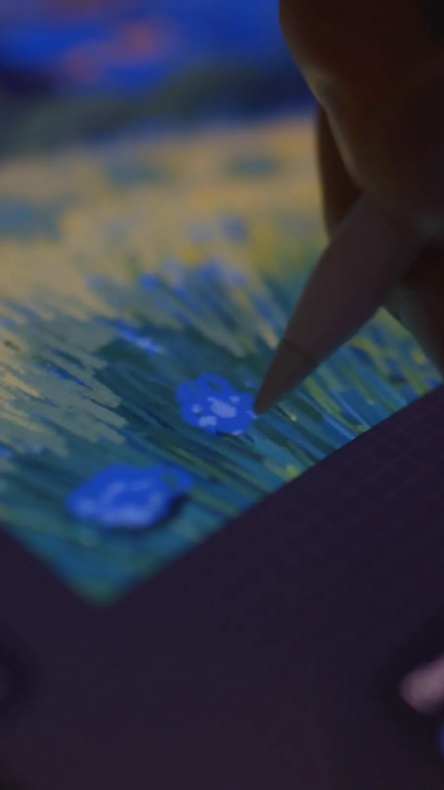 Close-up of painted flowers and grass texture on the iPad screen