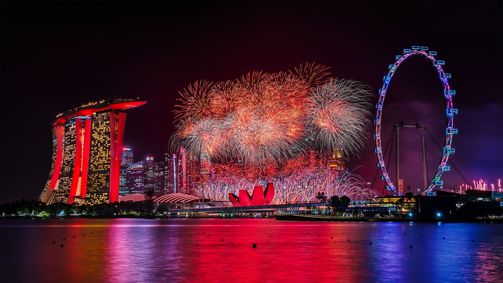 Red fireworks over Marina Bay Sands and the Singapore Flyer
