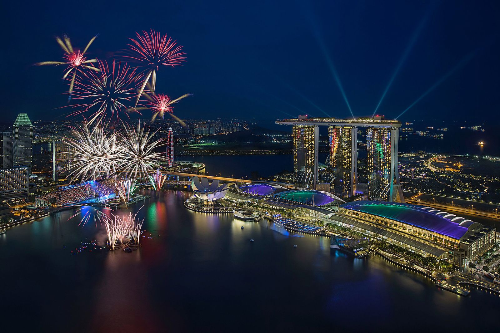 Aerial view of fireworks and light rays over Marina Bay Sands