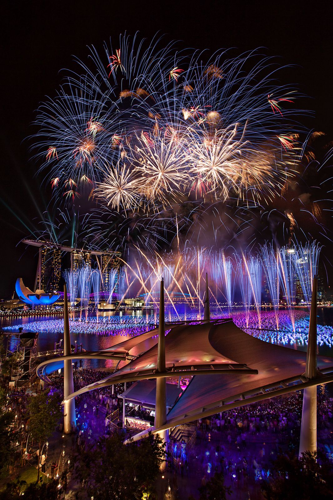 Golden fireworks cascading over the bridge, portrait orientation